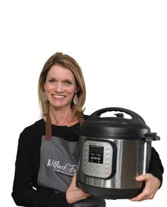 a woman holding an instant pot and smiling