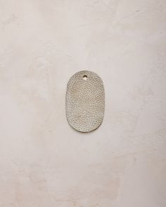 a white ceramic object hanging on the wall