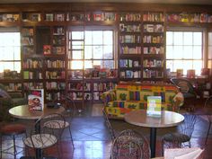 a library filled with lots of books and furniture