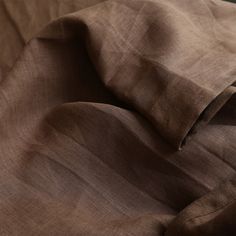 a close up view of a bed with brown sheets