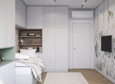 a bedroom with a bed, tv and shelves in the wall next to each other