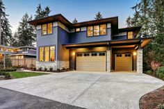 a large house with two garages in the front and one on the other side