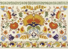 an ornately designed rug with colorful flowers and leaves on the border, is shown