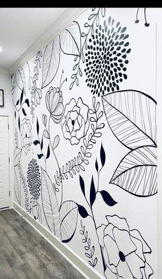 the wall is decorated with black and white flowers