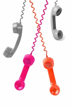 two telephones are connected to each other with corded phones in the same color