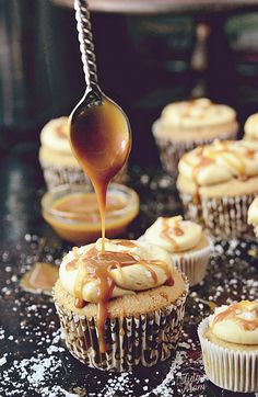 cupcakes with frosting and caramel being drizzled on top