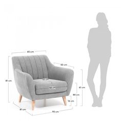 a person standing next to a gray chair with measurements on it and the size of the chair