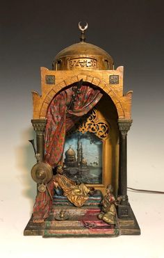 an ornate clock with a painting on it