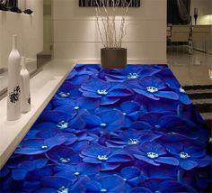 blue flowers are on the floor in this bathroom