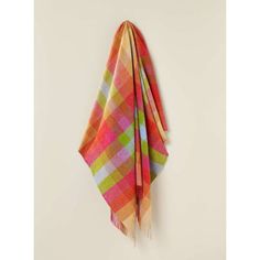 a multicolored plaid scarf hanging on a wall