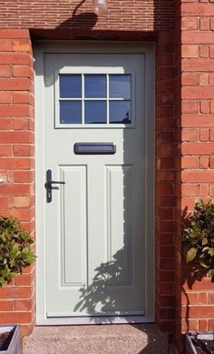 a white front door on a brick building