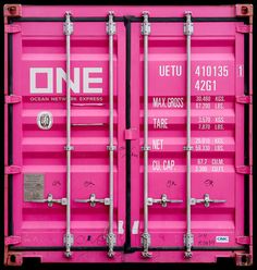 two pink shipping containers sitting side by side on top of each other in front of a black background