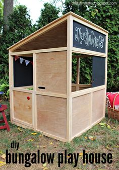 a wooden play house with chalkboard on the side and lettering that says, my bunglow play house