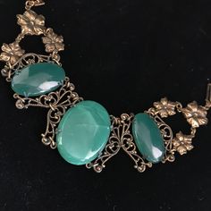 This bracelet was made by Sadie Green company in the seventies. Sadie Green would use antique and vintage components and marry them together to make great jewelry. They specialize in using green sea glass, these smooth pieces being a jade color.  Please note that the large 1.25 x .75 one in the middle has been cracked, but still intact. The price reflects this.  The glass cabs are set into antiqued brass filigree settings. The bracelet is all linked together and measures 7 inches fitting an average woman's wrist. The closure is a tongue in barrel style and still works well. The detail of the metal open work links are fantastic. It is a classic Belle Epoque design and weighty due to the glass components. This piece of jewelry is sent in a bubble pack envelope via US postal service, first cl Adjustable Vintage Jade Bracelets, Victorian Green Bracelets For Gifts, Victorian Green Bracelets As Gift, Victorian Style Green Bracelets For Gifts, Ornate Green Jewelry With Intricate Design, Vintage Jade Jewelry For Jewelry Making, Victorian Green Metal Jewelry, Green Brass Bracelet Jewelry, Vintage Green Bangle Jewelry