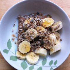 a bowl filled with rice and bananas on top of a wooden table