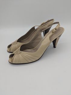 "Vintage 80's beige and brown leather peep-toe slingback heels by Bruno Magli. All real leather, made in Italy. Excellent condition, slight wear to the bottom of the sole but no other flaws found. Marked a size 8.5, but runs small. Best fits a size 7.5/8. Please check measurements. Length: 9.85\" Width: 3\" Heel height: 3.25\"" Beige Medium Width Open Toe Slingback Pumps, Beige Medium Width Slingback Pumps With Open Toe, Beige Slingback Pumps With Medium Width And Open Toe, Vintage Beige High Heel Sandals, Beige Vintage Open Toe Sandals, Vintage Beige Open Toe Sandals, Vintage Beige Leather Sandals, Vintage Leather Sandals In Beige, Beige Retro Open Toe Heels