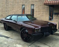 a very nice looking car parked in front of a building