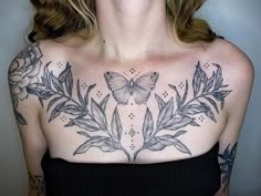 a woman with a butterfly tattoo on her chest