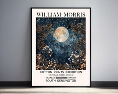 a poster is hanging on the wall in front of a gray wall with an image of a full moon