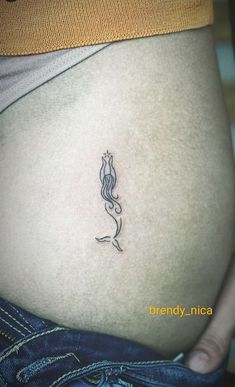 a woman's stomach with a small tattoo on it