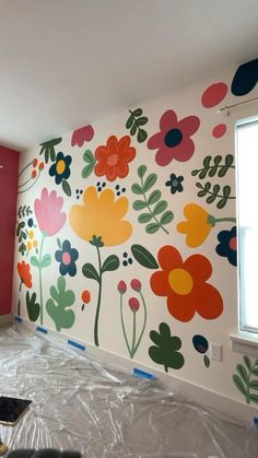 a room with flowers painted on the wall and plastic wrap around it's edges