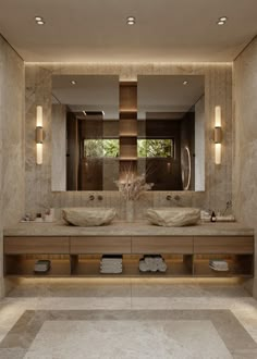 a large bathroom with two sinks and lights on the wall, along with other fixtures