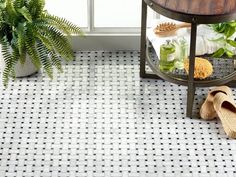 a white tiled floor next to a potted plant