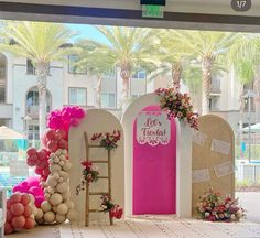 a decorated stage set up with balloons and flowers