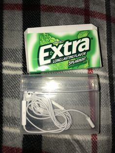 an extra power cord is laying on the bed next to a box of earplugs