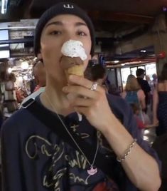 a young man eating an ice cream cone