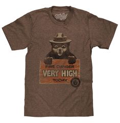 PRICES MAY VARY. Your New Favorite Smokey Bear T-Shirt: Show off your love for our national parks with the lovable Smokey Bear holding the classic "Fire Danger Very High Today" sign - distressed and printed on the softest brown heather tee we could find. Easy Care Tees: This Smokey Bear design is licensed and screen-printed on a soft, short-sleeve poly-cotton t-shirt that goes from the washing machine to the dryer without losing shape, shrinking or fading. Graphic is intentionally distressed for Smoky Bear, Bigfoot Drawing, Charlie Boy, Camping Clothes, Smokey The Bear, Wildland Fire, Smokey Bear, Smokey The Bears, Mens Fade