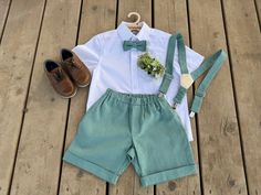 Dress your young gentleman in elegance with our Mint Linen Ring Bearer Outfit, ideal for any special occasion. This exquisite ensemble includes perfectly tailored mint linen shorts, durable suspenders with high-quality metal details, and a handmade bow tie, all designed for both style and comfort. Ideal for weddings, christenings, first communions, birthdays, and more, this outfit is suited for boys aged 1 to 6.  The silhouette of this set is charmingly captured in the accompanying photos - showcasing the relaxed fit of the shorts paired seamlessly with suspenders and a bow tie, epitomizing a neat yet playful look. The mint color of the linen is not only eye-catching but also conveys a sense of freshness and tranquility, making it an exceptional choice for various occasions. Ensure your li Ring Boy Outfits, Outfit With Shorts, Outfit Mint, Suspenders And Bow Tie, Ring Boy, Bearer Outfit, Ring Bearer Outfit, Christening Outfit, Ring Bearers