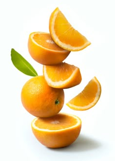 oranges stacked on top of each other with leaves