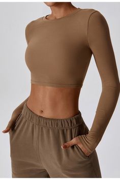 The Thalia Ribbed Round Neck Long Sleeve Active Top features a flattering, body-hugging fit that accentuates your curves while offering maximum support. The crop top length is perfect for showing off your toned midriff and pairs perfectly with high-waisted leggings or shorts. Fabric & fit: 78% Nylon 22% Elastane Model is wearing size Small. Body Hugging Tops, Active Top, Swimwear Sale, High Waisted Leggings, Shirts Tops, Round Neck, Crop Top, High Waisted, Leggings