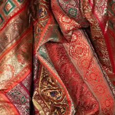 An Indian vintage large silk embroidered fabric from the second half of the 20th century with red, orange, purple, green and golden tones among others. Possibly originating from Rajasthan, this stunning silk fabric is made of sari pieces that were sewn together. Mesmerizing us with its embroidered floral and elephant motifs as well as its rich tones, this 40 or 50 year old luscious and shimmering fabric, lined in the back will be a sumptuous decorative accent in any home, perhaps used as a bedsp Asian Fabric Pattern, Psychic Decor, Pirates Of The Caribbean Wedding, South Asian Aesthetic, Asian Fabric, Red Shawl, Evolution Of Fashion, Indian Textiles, Embroidery On Clothes