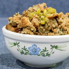 a white bowl filled with food on top of a blue tablecloth covered ground beef