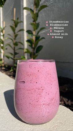 a pink glass sitting on top of a cement slab