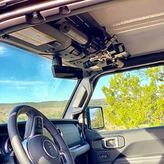 the interior of a vehicle with dashboard, steering wheel and sunroofing area