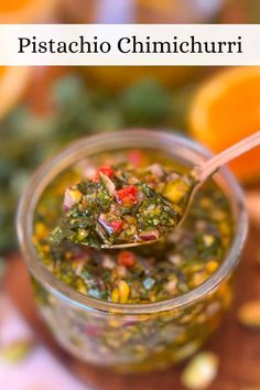 a spoon full of pesto chimichurri on top of an orange slice