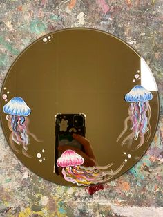 there is a mirror with jellyfishs on it and a person taking a photo