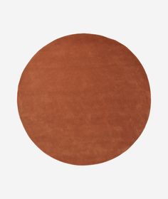 a round brown rug on a white background