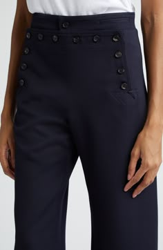 Inspired by Navy pants from the 1940s, these sailor trousers made of wool twill reproduce the wide-leg silhouette and distinctive front-button placket. 30 1/2" inseam; 20" leg opening; 12 1/4" front rise; 16 1/2" back rise (size 26) Front button closure Front button-welt pockets; back welt pocket Partially lined 100% virgin wool Dry clean Made in Portugal Designer Clothing Side Buttons Pants, Classic Pants With Button Closure, Non-stretch Full-length Bottoms With Button Closure, Classic Pants With 4-way Stretch And Welt Pockets, Luxury Mid-rise Pants With Button Closure, 1940s Sailor Pants, Sailor Pants, Chic Over 50, Sewing Pants