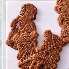 some cookies are on a white plate and one is decorated with an image of two people