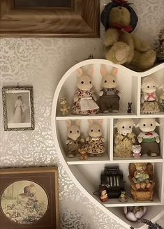 a heart shaped shelf filled with stuffed animals