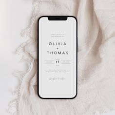 an iphone case sitting on top of a white blanket with the words,'ollivia thomas 17 '