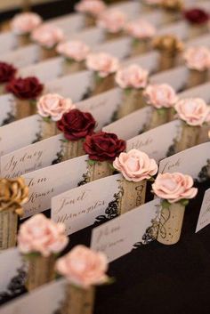 there are many place cards with flowers on them for guests to write in the envelopes