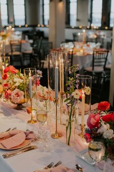 the table is set with candles and flowers