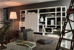 a living room filled with furniture and bookshelves next to a ladder in front of a window