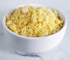 a white bowl filled with food on top of a table