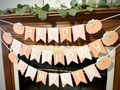 a happy birthday banner hanging from a fireplace